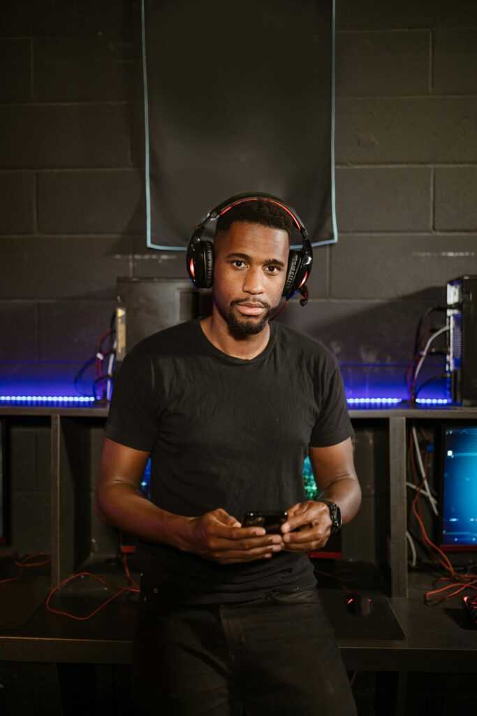 A focused gamer in a modern setup, wearing headphones, immersed in esports.